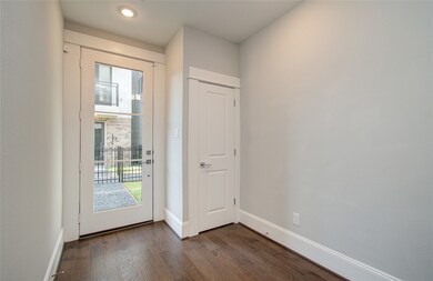 This is a well-lit entryway featuring a modern fro