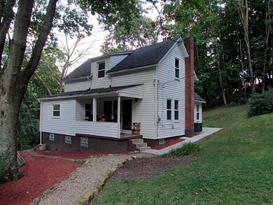 Exterior Back. Covered porch looks out over the pr