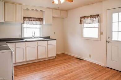 Updated eat-in kitchen with white cabinetry and ba