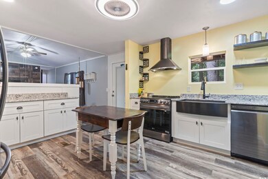 Kitchen featuring wall chimney range hood, ceiling
