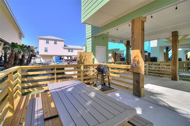 Side porch with picnic table, grill, and shower