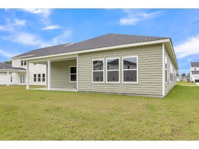 Back of property with a lawn