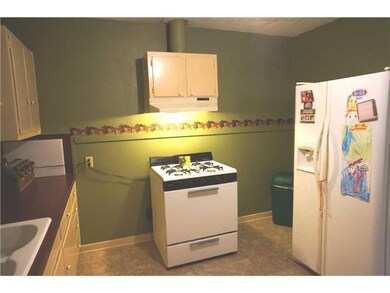 Kitchen. View of Range Oven, Refrigerator that rem