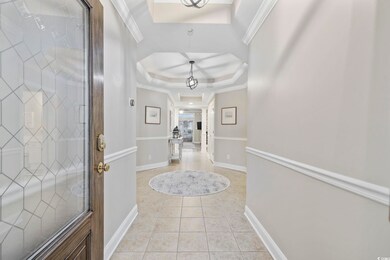 Foyer featuring light tile patterned flooring, orn