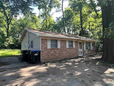 Single story home featuring brick siding and a patio