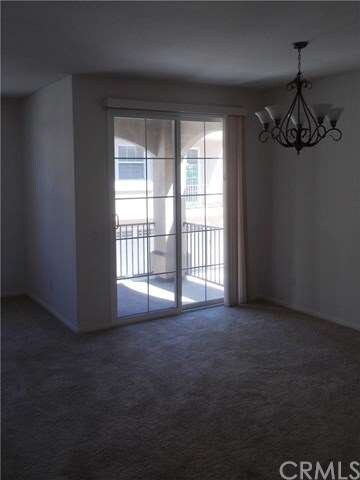 Dining area has hanging light and patio access