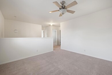 Unfurnished room featuring attic access, light ca