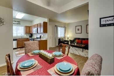 Dining space with light wood-style floors and heal
