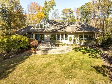 Back of house featuring a patio area and a lawn