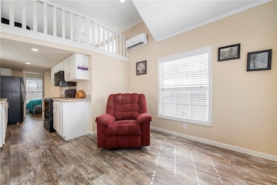 Living Area has vaulted ceiling with opening to th