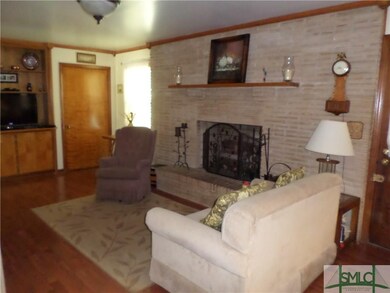 Family with wood floor, fireplace with gas logs