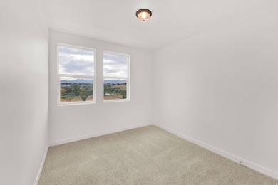 Carpeted spare room with baseboards and a mountain view