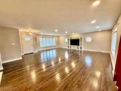 Unfurnished living room with dark wood finished floors and recessed lighting