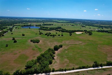 Birds eye view of property with a water view and a