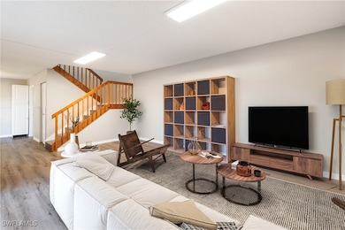 Living room with hardwood / wood-style flooring