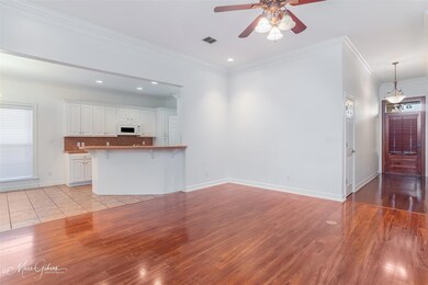 Unfurnished living room featuring ceiling fan, lig