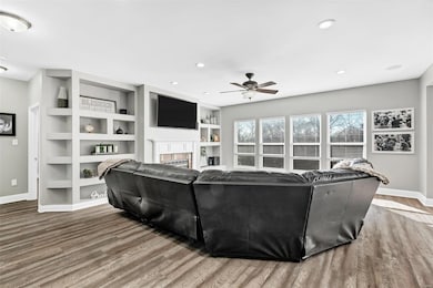 Great room has built in shelves, cozy gas fireplac