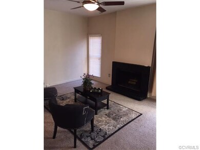 Spacious Living Room has a wood burning fireplace.