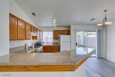 Kitchen featuring under cabinet range hood, visibl
