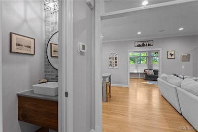 Hallway with light wood finished floors, ornamenta