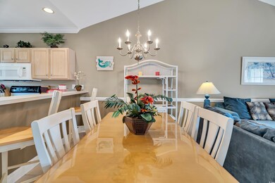 Dining area with an inviting chandelier and lofted