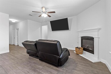 Living room with light hardwood / wood-style floor