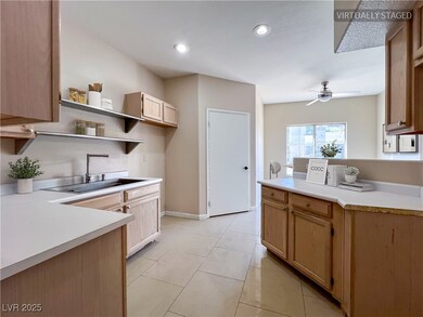 Kitchen featuring a ceiling fan, open shelves, lig
