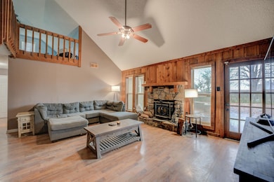 Living room with wooden walls, high vaulted ceilin