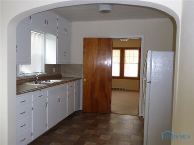 Kitchen opens to first floor room that could be di
