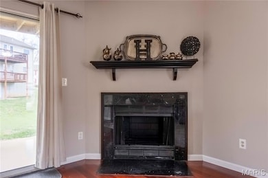 Detailed view of wood finished floors and a tile fireplace