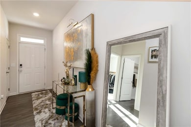 Foyer with baseboards and dark wood-type flooring