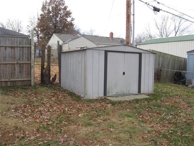 outside storage building, corner of fenced yard