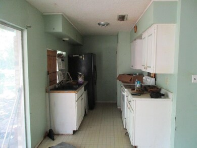 Kitchen featuring electric stove, sink, and white 