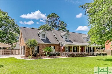 Beautiful front exterior! Mature landscaping, huge porch & shady trees!