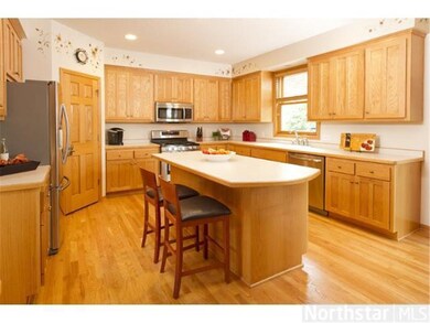 The roomy kitchen has a large island, walk-in pant