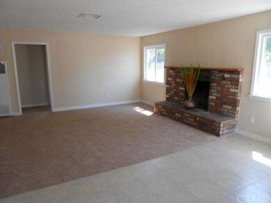Living room has a brick fireplace.