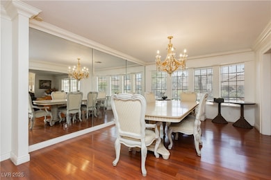 Dining space with a chandelier, dark wood-style fl