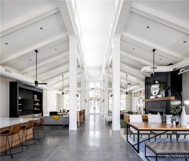 Clubhouse with ceiling fan, concrete floors, beame