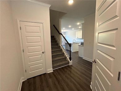Stairway with wood finished floors and recessed lighting