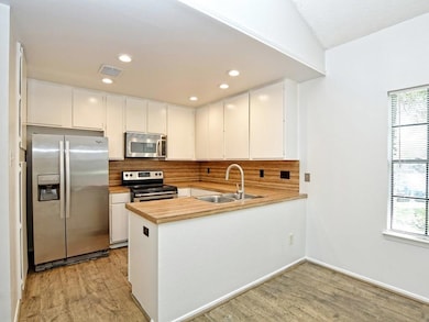Kitchen with tasteful backsplash, visible vents, 
