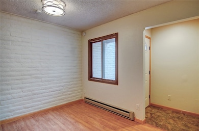 Dining room featuring a baseboard radiator, light