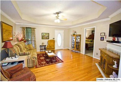 Living room has beautiful hardwood floors and open