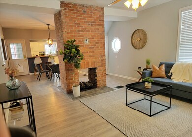Open concept ~ double sided exposed brick fireplac