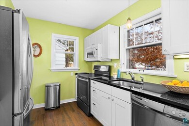 Kitchen featuring white cabinetry, stainless steel