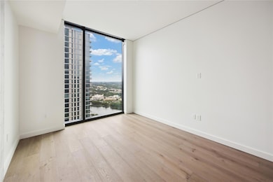 Empty room featuring floor to ceiling windows, li