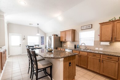 A breakfast bar, kitchen island with side outlets,