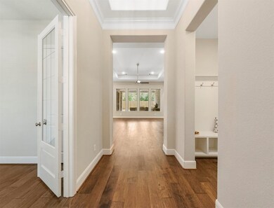 Front entry with wood floors that go throughout the main areas of the home, except bedrooms. To the left is the home office/study with french doors, and to the right is a mud room and laundry.