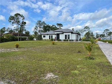 View of front of home featuring a front yard, a st