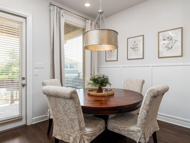 Dining area with dark wood-style floors, recessed