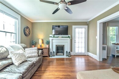 Gorgeous hardwoods, crown moldings.  Door to the right of the fireplace leads to the screened porch and deck.
